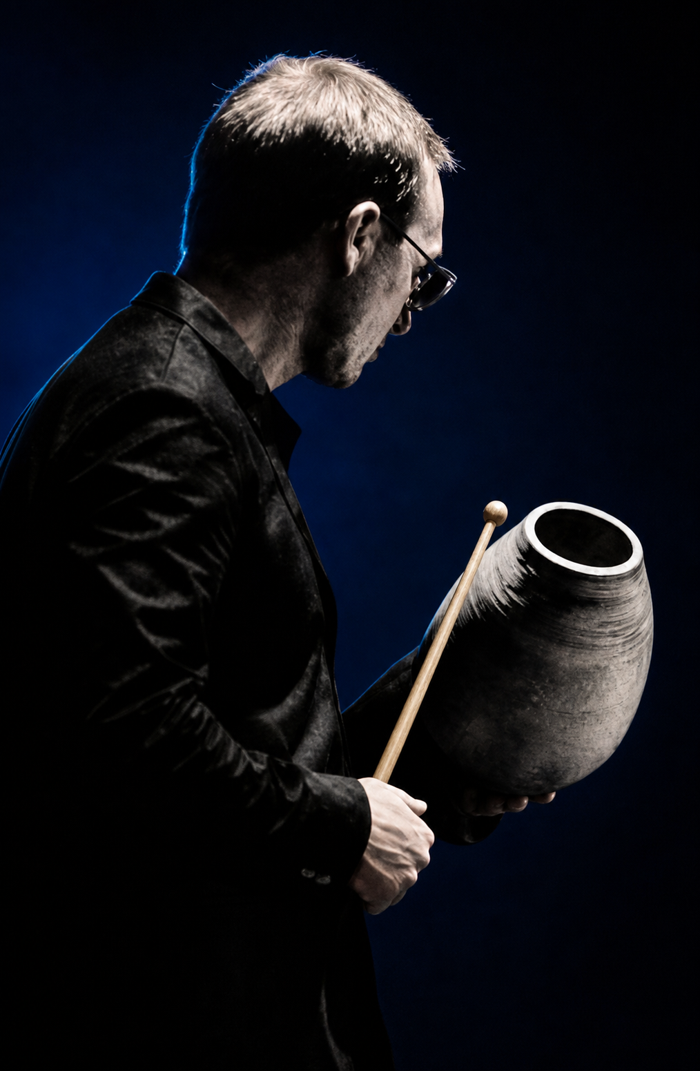 Brayan Castillo, chef du Big Band Carrément Jazz, tenant une percussion et une baguette